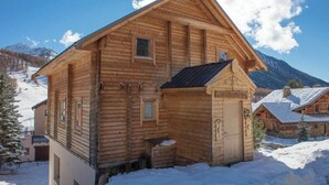A wooden cabin with a gabled roof, a small porch, and a window. - Chalet Anais, traditional Alpine feel (Montgenevre)