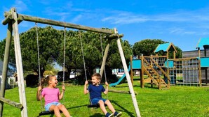 A playground with swings and a climbing structure. - House La Houle Erquy *Pool* *Beach at 800m* (Erquy)