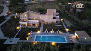 A two-story stone house with a swimming pool, outdoor seating, and a well-maintained garden. - Abeloessa Methonian Hospitality (Pylos-Nestoras)