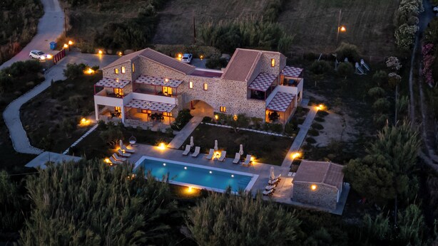 A large, multi-story stone building with a swimming pool and outdoor seating areas. - Abeloessa Methonian Hospitality (Pylos-Nestoras)