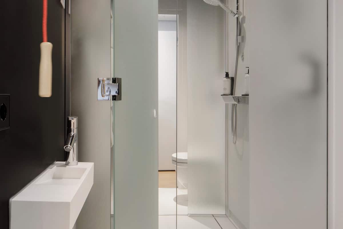 zoku room | bathroom | shower, rainfall showerhead, eco-friendly toiletries, hair dryer