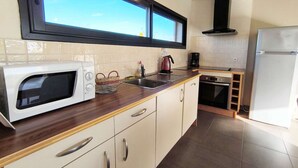 Una cocina moderna con microondas, fregadero y estufa.