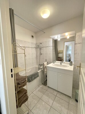 Bathtub, hair dryer, towels, soap