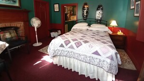 A bedroom with a bed, a fan, a fireplace, and a ceiling fan. - Cobbler Suite, Private Entrance and Private bath, 100% NO SMOKING PROPERTY! (Hermann)