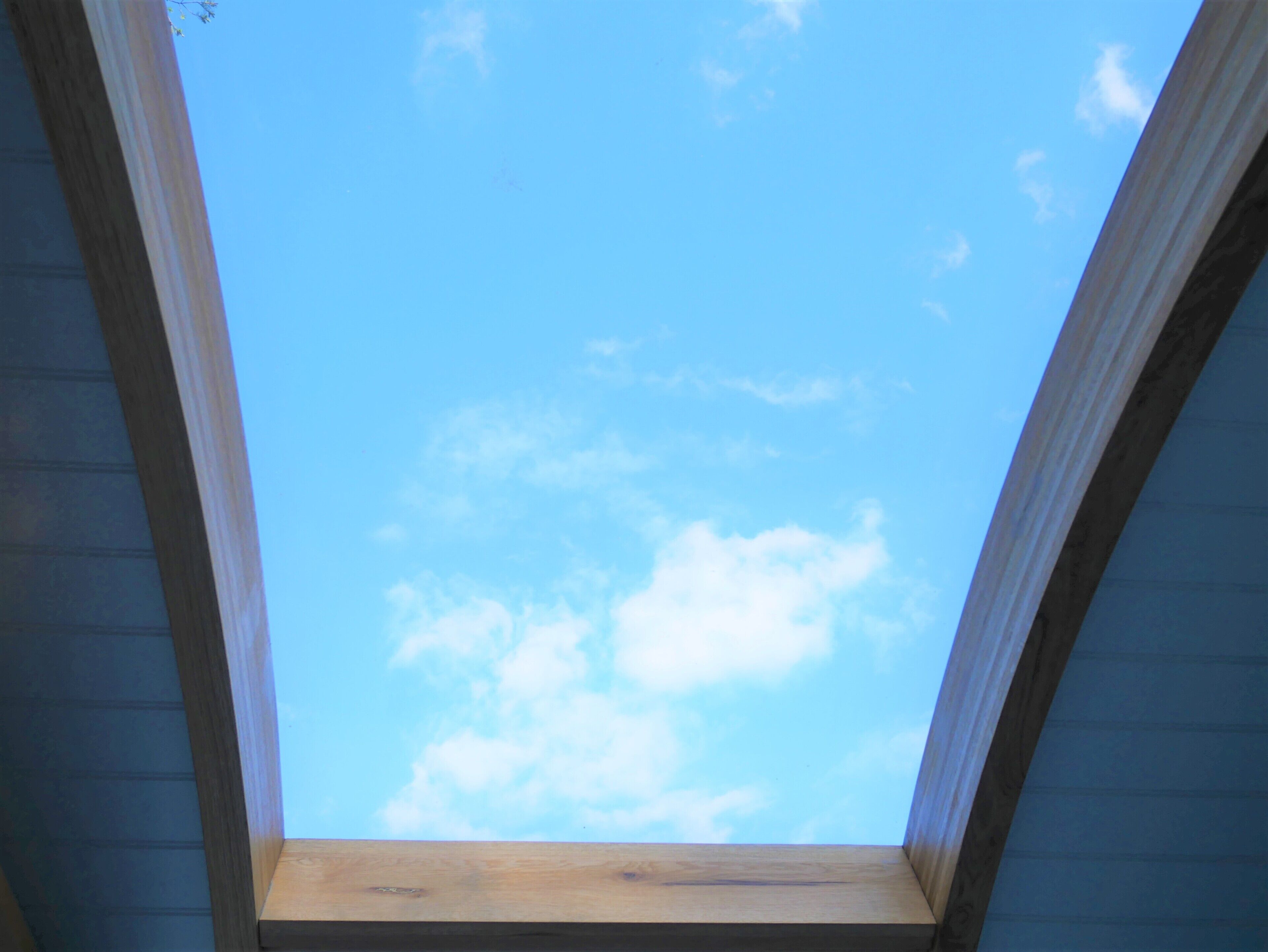 A skylight with a clear blue sky view.