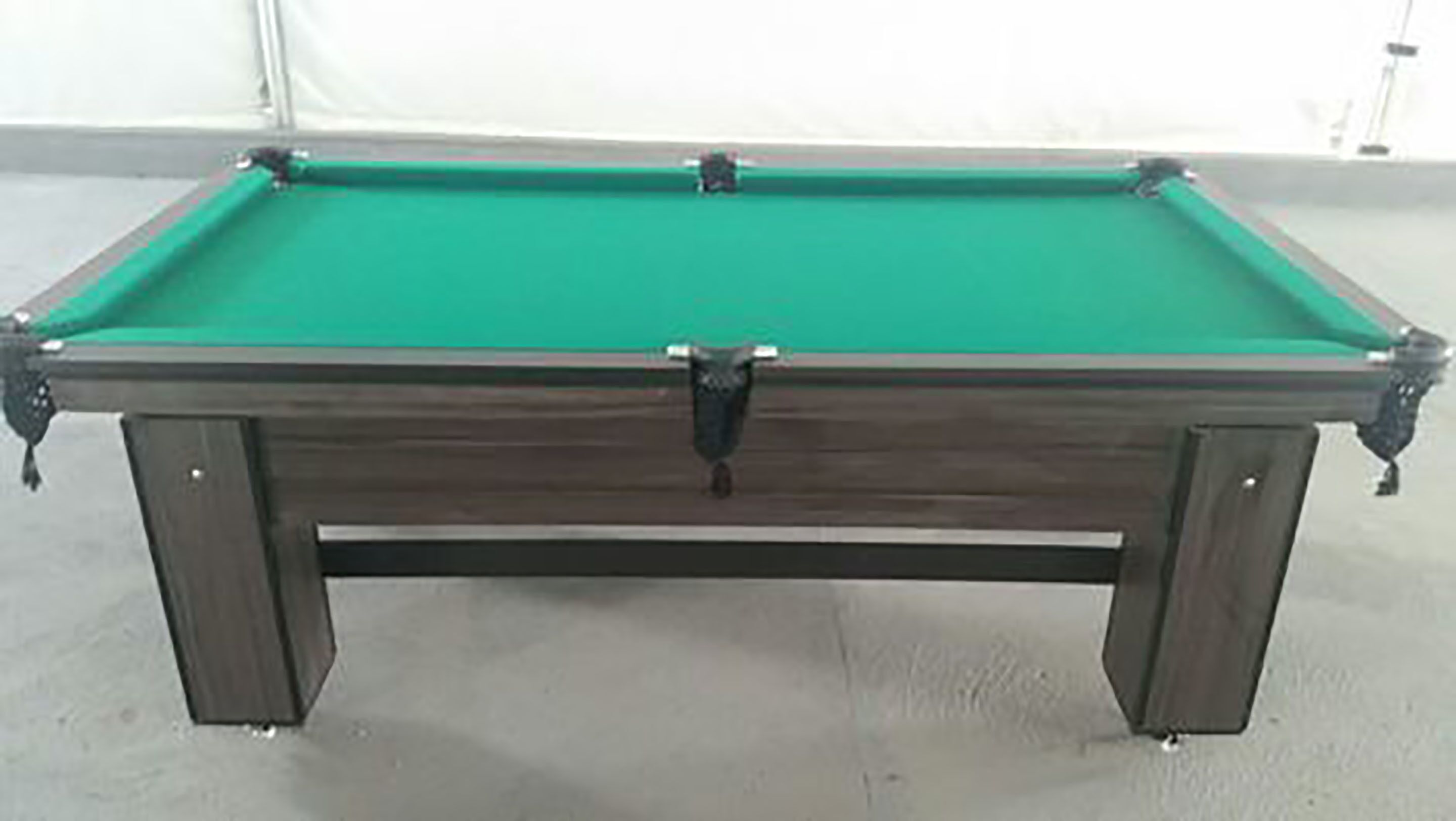 A pool table with a green felt surface and a wooden frame.