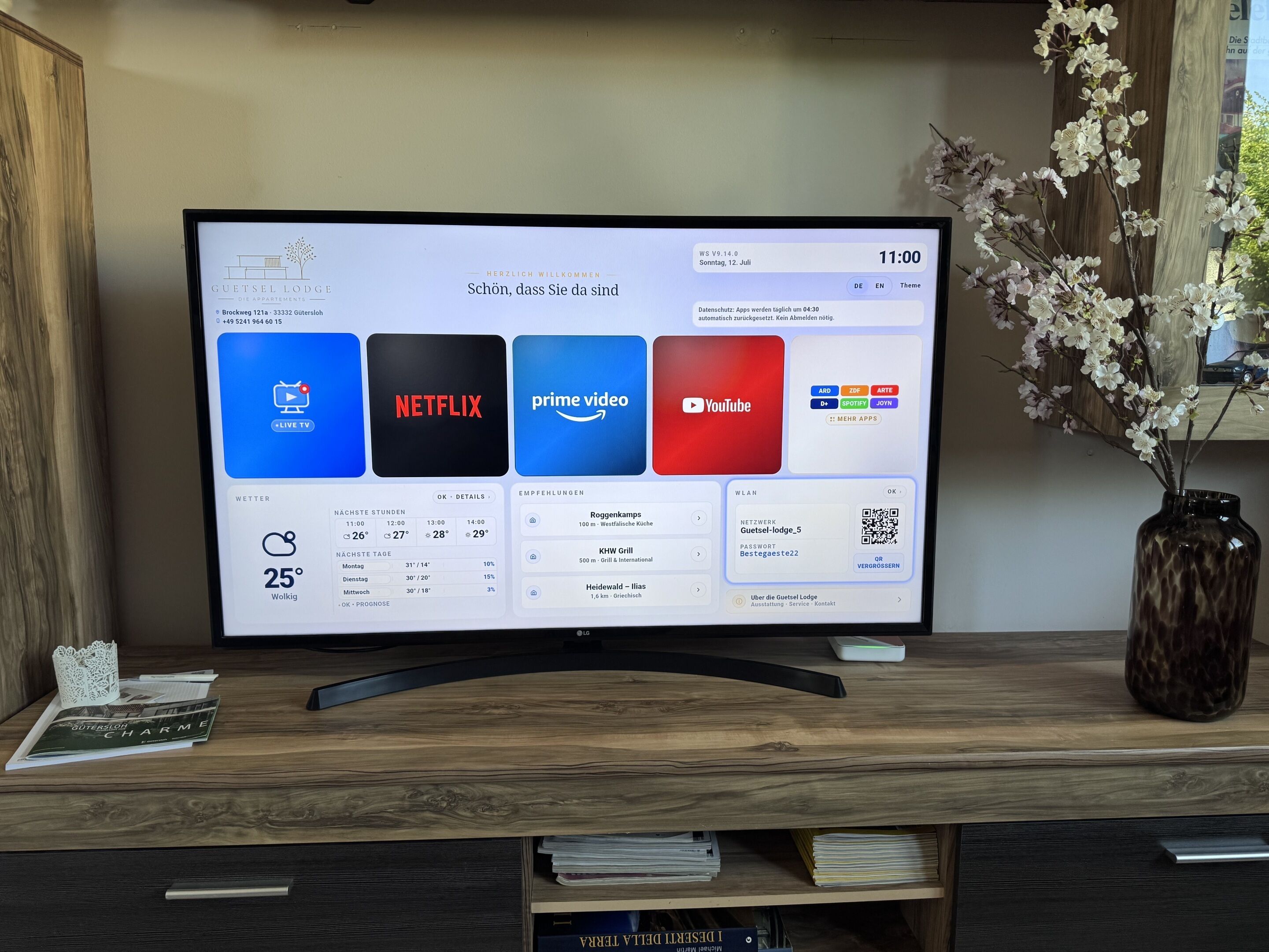 A hotel room with a large TV displaying various streaming services.