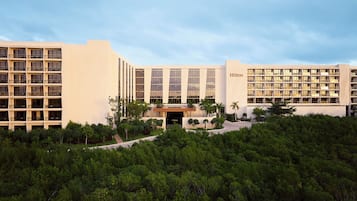 A multi-story hotel with a modern design, featuring a prominent entrance and multiple balconies.