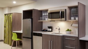 A compact kitchen with a built-in microwave, a dishwasher, and a coffee maker. - Home2 Suites by Hilton Ft. Lauderdale Downtown, FL (Fort Lauderdale)