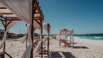 On the beach, white sand, beach umbrellas, beach towels