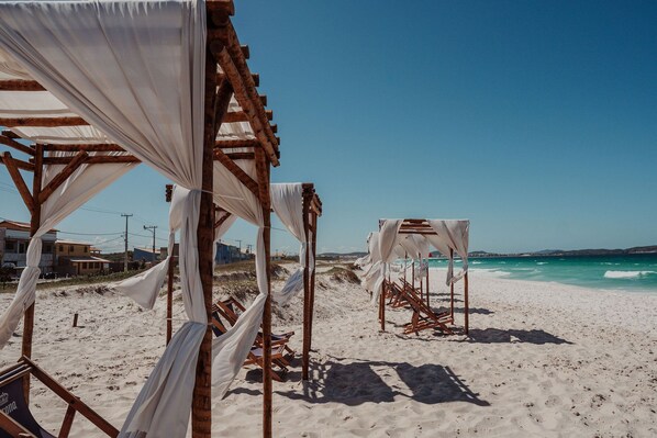 On the beach, white sand, beach umbrellas, beach towels