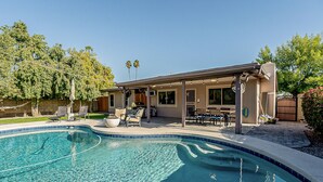 A residential property with a swimming pool, outdoor seating, and a covered patio. - Modern Oasis with Pool in the Valley of the Sun (Tempe)
