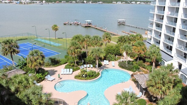 A resort with a swimming pool, tennis courts, and a view of the water. - 507 "A" Relaxing Bliss! Sept 13-20 Open! Book Soon! (Gulf Shroes)