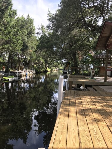 Waterfront Retreat with fenced yard, porch + bar, canal views, NEW DOCK