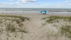 A beach path leading to a blue umbrella and beach chairs. - Captain’s Quarters - Private Beach Access! (Atlantic Beach)