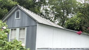 A two-story house with a porch and a wooden fence in the foreground. - PET FRIENDLY MAIN STREET LOFT, WALKING DISTANTANCE TO OLD TOWN TOMBALL (Tomball)