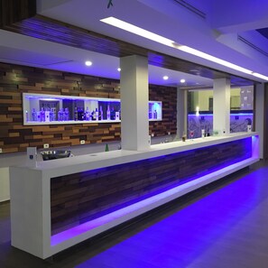 A modern reception desk with a wooden panel design and a blue-lit counter.