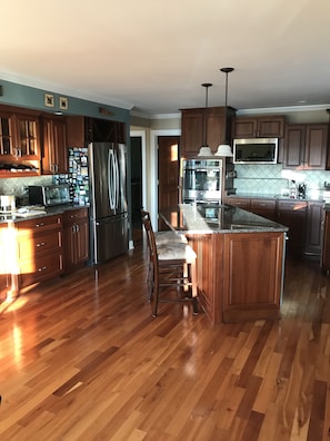 Enjoy cooking in this well-equipped kitchen with a central island and bar stool.