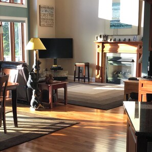 Relax in this inviting living room with a comfortable sofa, fireplace, and television.