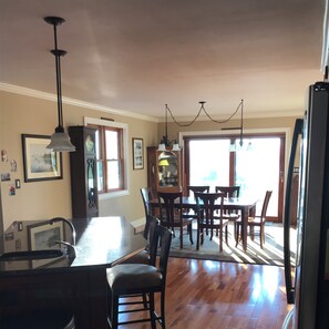 Enjoy meals in the central island kitchen with a large dining table and comfortable chairs.