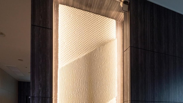 A modern interior with a textured wall panel and a dark wooden panel. - R&B Hotel Nagoya-Ekimae (Nagoya)