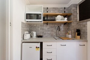 Fridge, microwave, stovetop, coffee/tea maker