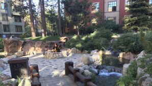 A wooden bridge over a small stream with rocks and greenery around. - The Village At Mammoth, 2BR/2B Suite, Great Location Above Shops & Restaurants   (Mammoth Lakes)