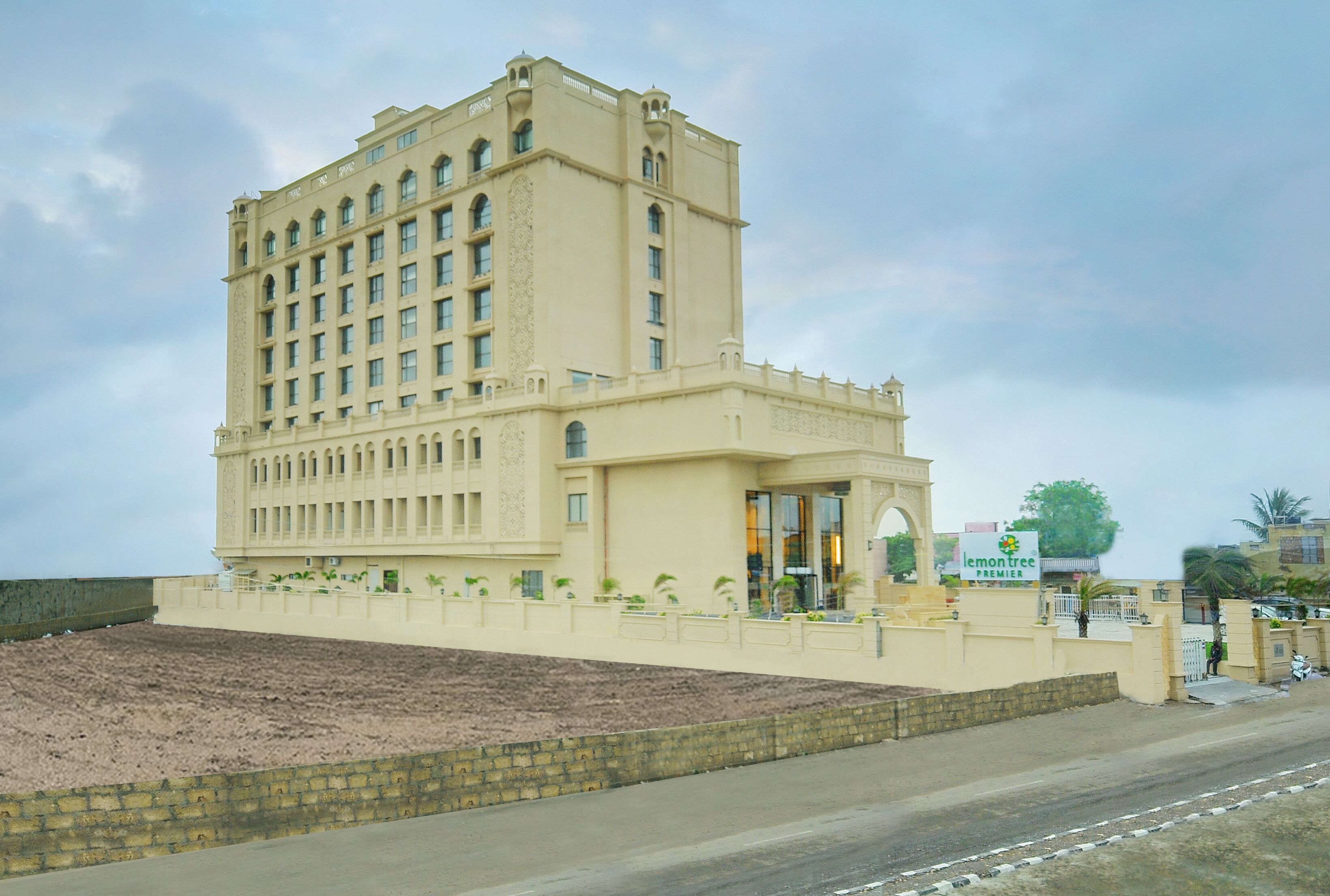 A large, multi-story hotel with a prominent entrance and a landscaped area in front.