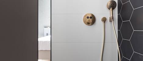 A bathroom with a shower, a toilet, and a sink.