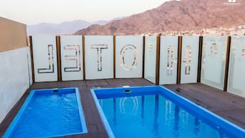 2 outdoor pools, open 7:00 AM to 6:00 PM, pool loungers