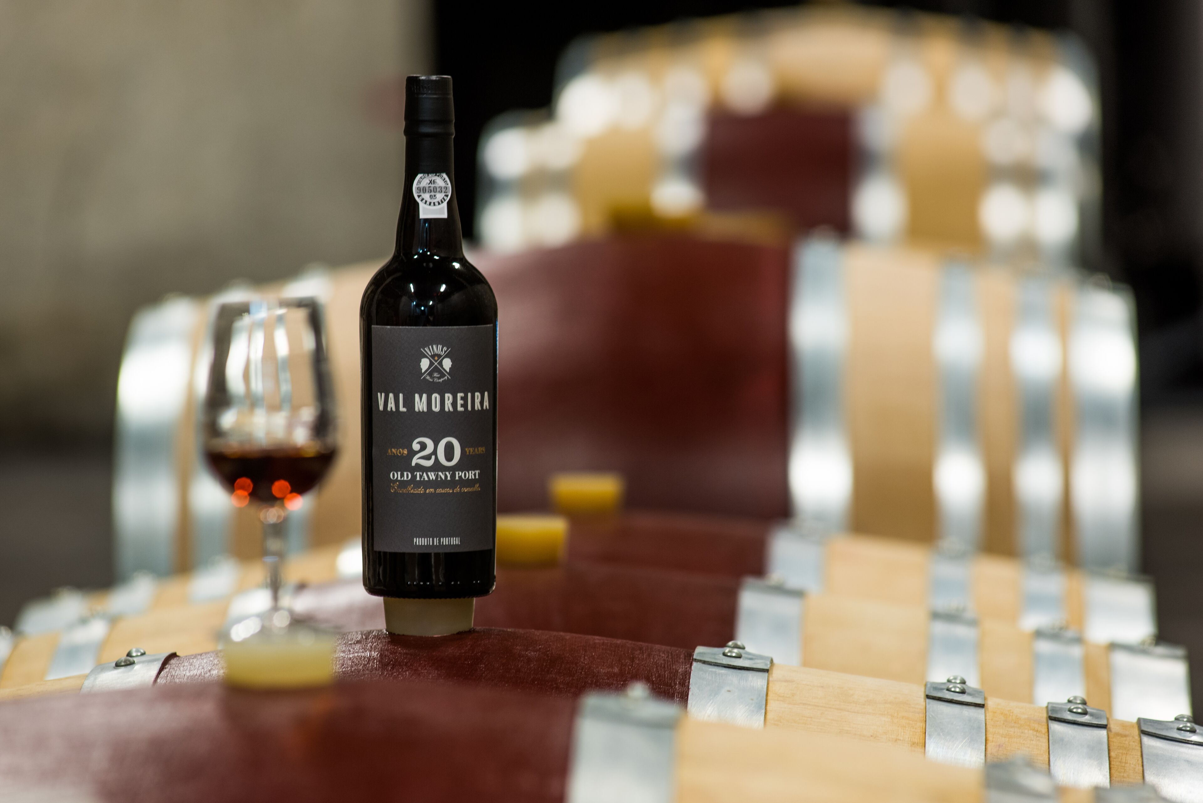 A bottle of wine on a wooden surface with a blurred background.