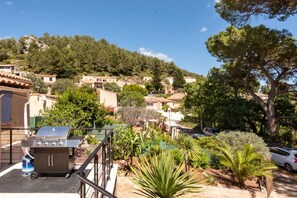 Residential homes blend seamlessly into the lush surroundings, offering a serene environment with outdoor cooking spaces.