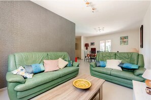Relax in this inviting living room with two sofas and a coffee table, perfect for socializing and unwinding.