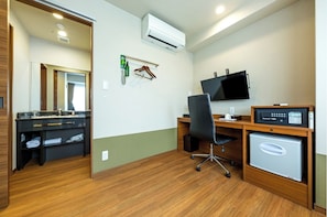 Enjoy a functional stay with a desk, flat-screen TV, compact refrigerator, and kitchenette.