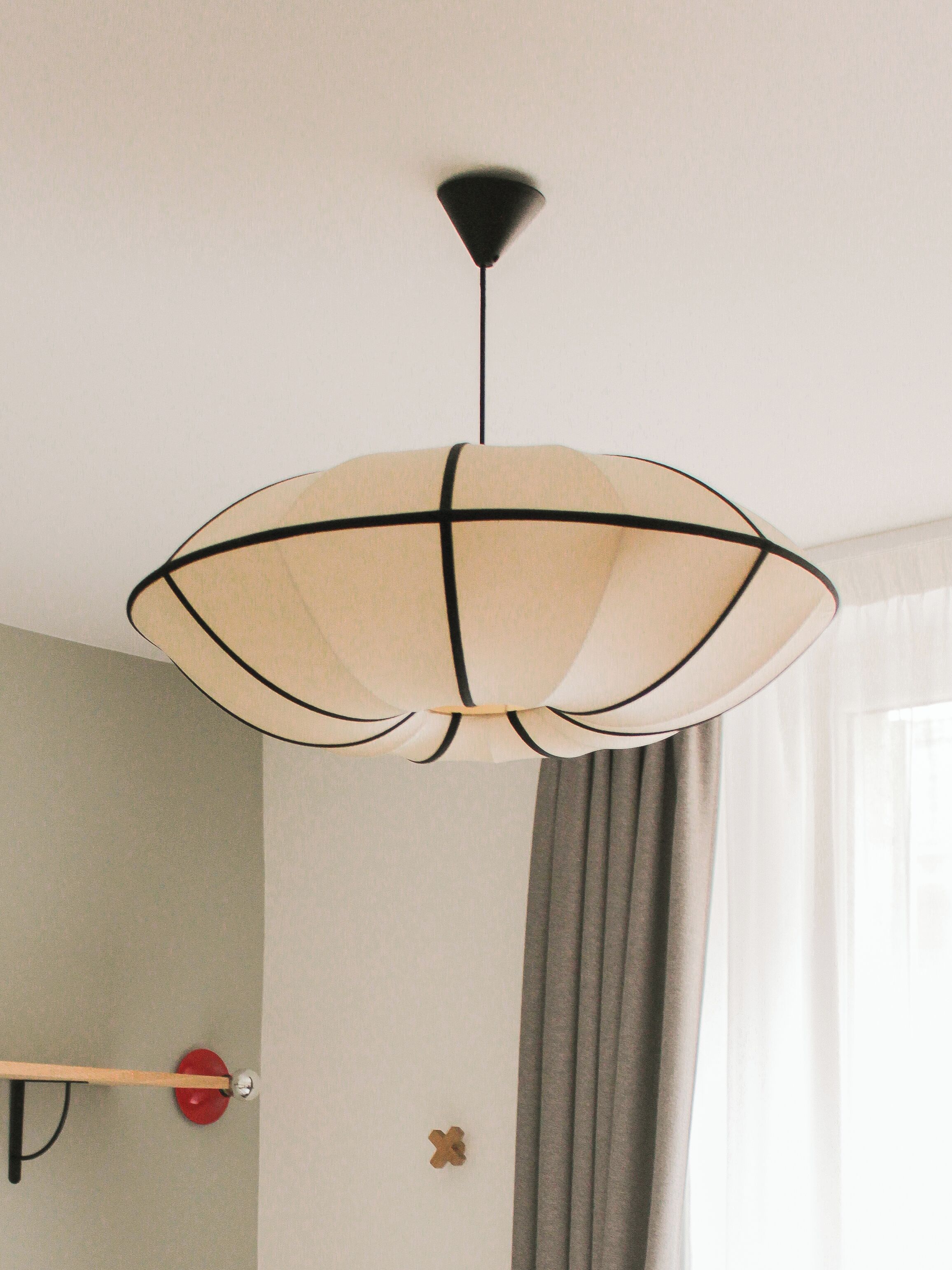 A ceiling-mounted light fixture with a geometric design.