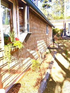 Stylish home with a brick exterior, metal-framed window, and a charming planter.