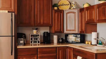 Fridge, microwave, coffee/tea maker, cookware/dishes/utensils