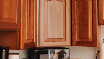 Fridge, microwave, coffee/tea maker, cookware/dishes/utensils