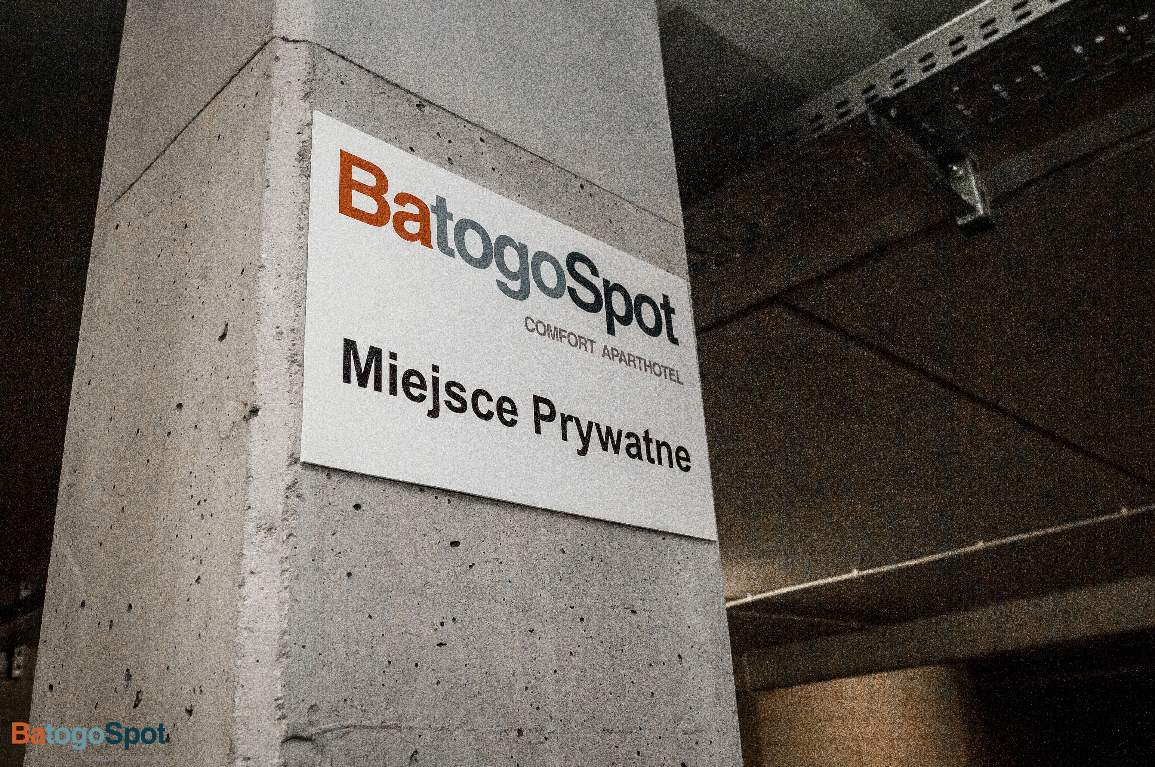 A sign for BatogoSpot, a comfort apartment hotel, located at Miejsce Prywatne.