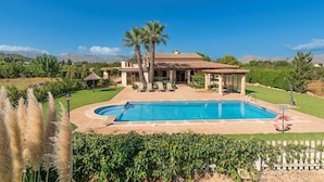 A house with a swimming pool, palm trees, and a well-maintained lawn. - 3 bedroom villa, with private pool and BBQ, Pollensa (Pollensa)