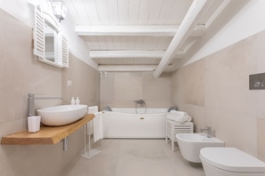 Bathtub, hair dryer, towels, soap