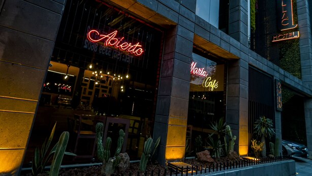 A building with a neon sign reading "Abierto" and "Narta Café". - Cadillac Hotel Boutique (Mexico City)