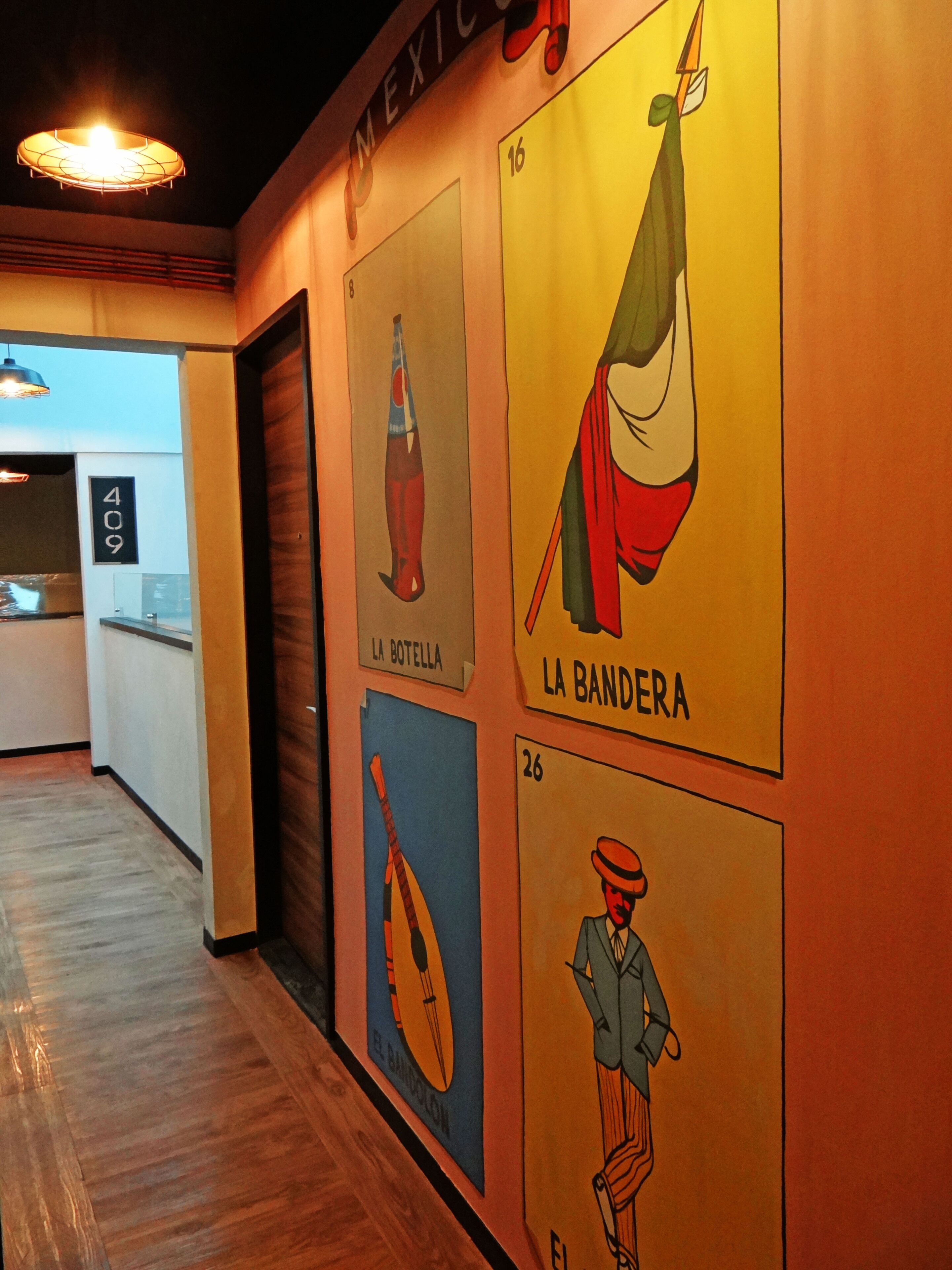 A hallway with numbered signs, each depicting a different cultural icon.
