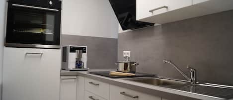 Fridge, stovetop, dishwasher, coffee/tea maker