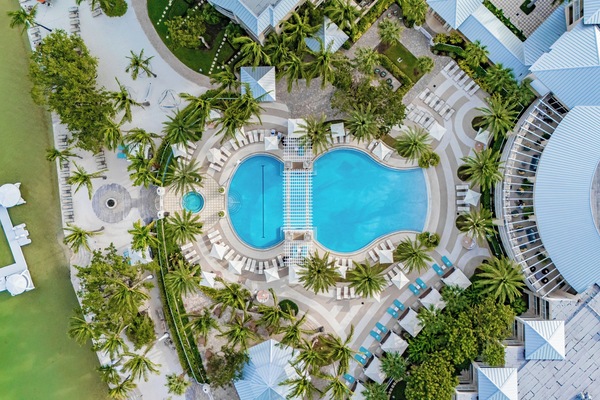 Resort pool with cabanas & palm trees 🌞 — available for all guests (not a private pool).