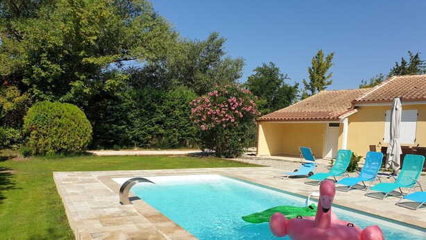 A swimming pool with a diving board, inflatable toys, and lounge chairs. - The Provençal villa. (Sarrians)
