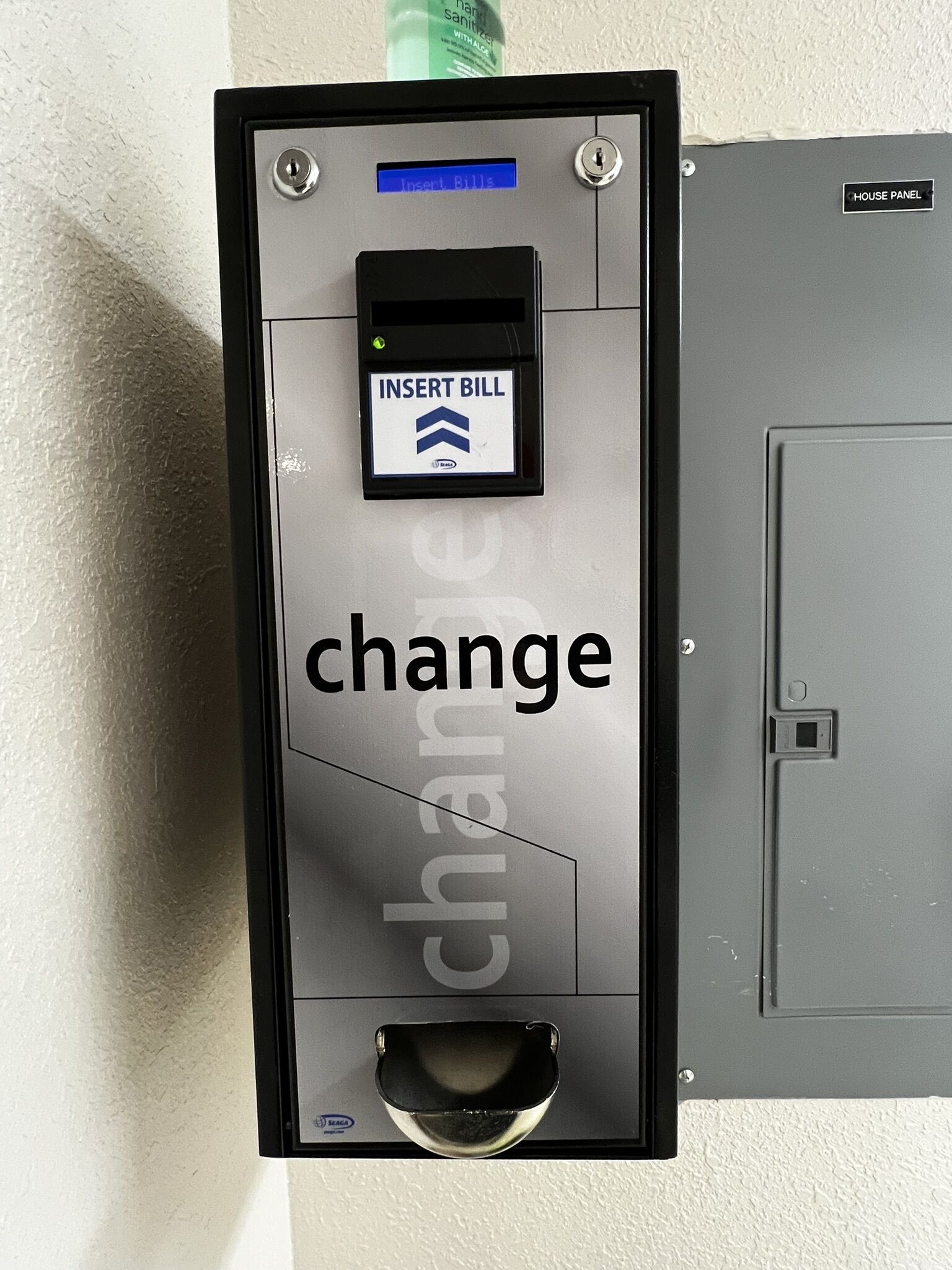 A utility box with a digital display and a keypad for inserting bills, labeled "INSERT BILL".