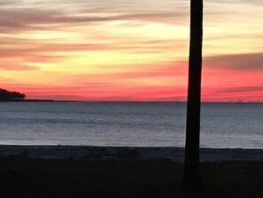 Ranta lähistöllä, aurinkotuoleja, rantapyyhkeitä