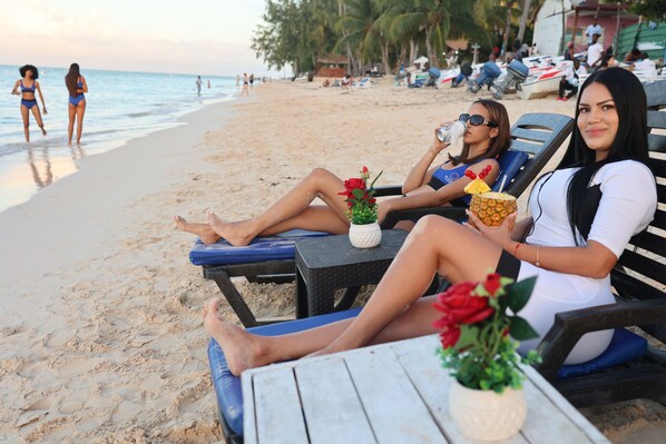 On the beach, white sand, sun-loungers, beach umbrellas