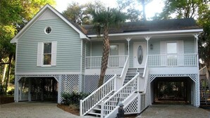 A two-story house with a porch, a staircase, and a garage.